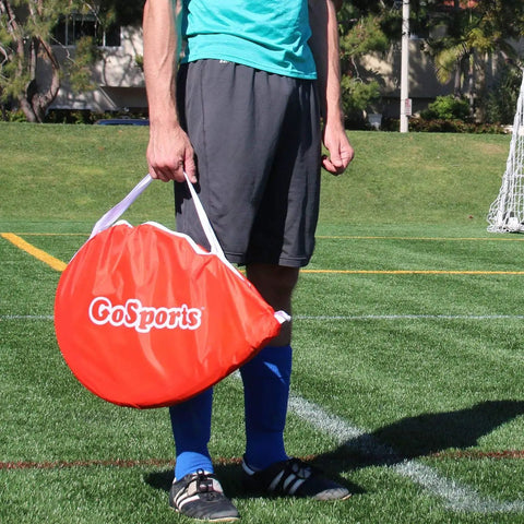 Person holding carrying case with Portable Pop Up Soccer Goals For Backyard Set Of Two 4 Foot Nets With Agility Training Cones And Carrying Case Easy Setup So You Can Play Anywhere Outdoors For Kids And Adults