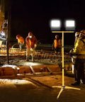 Adjustable Foldable Metal Tripod Archery Target Stand with built-in work light illuminating a construction site at night