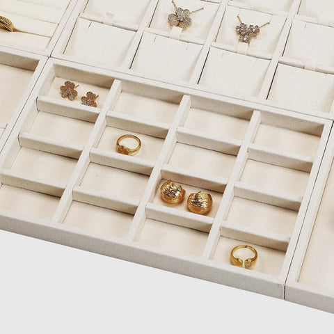 Totally Sweet Beige Linen Jewelry Display Tray With Sixteen Grid Slots For Rings Necklaces And Bracelets Ultra Soft Fabric Organizer showcasing various gold jewelry pieces.