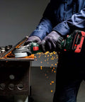 User operating Built Tough Brushless 18V Cordless Flat Head Angle Grinder 125 MM Disc on metal with sparks flying.