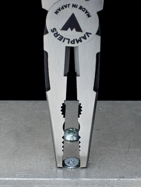 Close-up view of Caiman 7.5 Inch Stripped Screw Extractor Needle Nose Pliers with wire cutter crimper made in Japan, gripping a screw.
