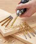 Top Shelf Eight Piece HSS Step Drill Bit Set With Titanium Coating And Hex Shank For No Sweat Serrated Side Cutting From Three To Ten Millimeters being used on wood.