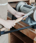 BG-GRIND4 four-piece grinding jig set close-up sharpening wood chisels on a bench grinder