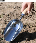 Beefy Capacity Garden Scoop Stainless Steel Soil Shovel with beech handle in use, ideal for home garden and farm use.