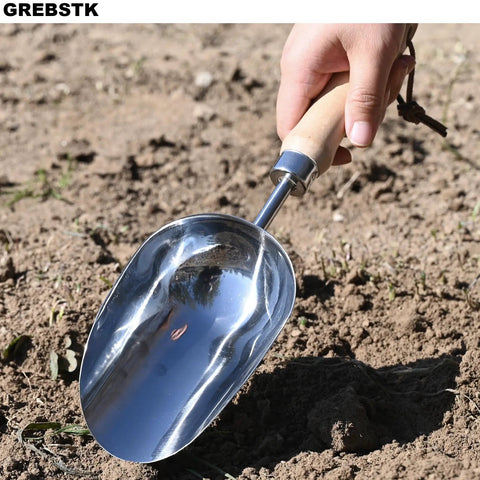 Beefy Capacity Garden Scoop Stainless Steel Soil Shovel with beech handle in use, ideal for home garden and farm use.