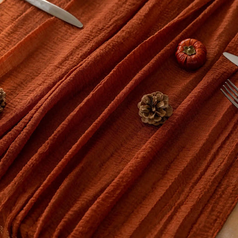 Rustic Fall Thanksgiving Table Runner Terracotta Cheesecloth Weave 120 Inches Long Hand Dyed Soft Cotton Gauze with pinecones and mini pumpkins.