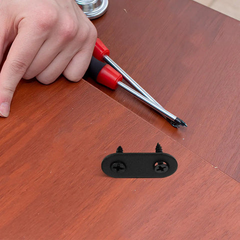 12 Sets Black Stainless Steel Flat Mending Brackets With Screws for Cabinets and Furniture Repair placed on wooden surface