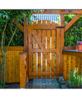Wooden garden gate with black gate hinges with screws, installed, surrounded by lush greenery, showcasing durable outdoor use.