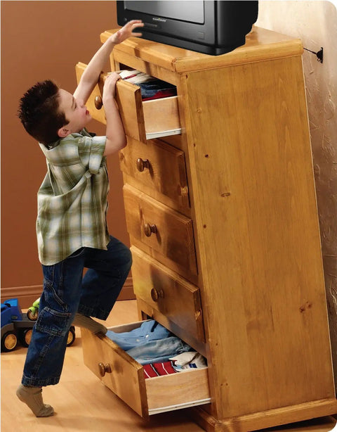 Child climbing on a wooden dresser illustrating need for Heavy Duty Anti Tip Kit That Keeps Furniture From Falling Up To 400lbs With Tamper Resistant Steel Cable System For Cabinets Filing Cabinets And Full Length Mirrors Galvanized Hardware Easy Install For Safer Home.