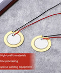 Close-up of 27mm discs with prewired leads from 20 Piece Piezo Pickup Kit With 27mm Piezo Discs Transducers Contact Microphones And Drum Trigger Ready Elements Prewired 3.94 Inch Leads For Acoustic Instruments And Sound Sensor Projects Plug And Play on stone background.
