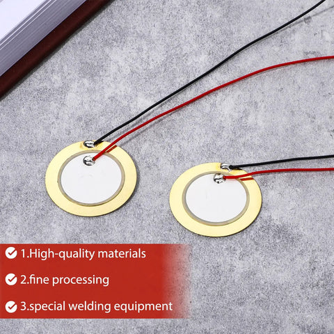 Close-up of 27mm discs with prewired leads from 20 Piece Piezo Pickup Kit With 27mm Piezo Discs Transducers Contact Microphones And Drum Trigger Ready Elements Prewired 3.94 Inch Leads For Acoustic Instruments And Sound Sensor Projects Plug And Play on stone background.