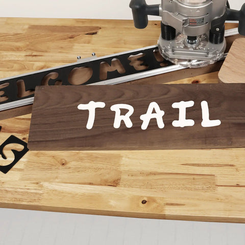 Heavy Duty Complete Sign Router Template Set For Custom Letters And Numbers In 1.5 Inch And 2.5 Inch Sizes With Full Alphabet And Characters Super Duper Easy Alignment For Your Weekend Shop Projects And Killer Diy Creations Right Now, showing the word TRAIL on wood.