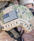 Sidewinder 55 Lumen Compact II Military Flashlight With Non Rechargeable Batteries, mounted on camouflage helmet