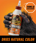 Wood Glue 8 Ounce Bottle Natural Wood Color Indoor and Outdoor Water Resistant Bond for Woodworking Projects held by hand