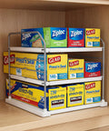 Heavy Duty Expandable Three Tier Kitchen Cabinet Organizer And Pantry Shelf Rack holding Ziploc and Glad food storage boxes.