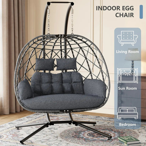 Two Person Double Egg Swing Chair With Stand For Outdoor And Indoor Hangout Cozy Cushions And Headrests Weatherproof Wicker Sturdy Steel Frame 650 Lbs Capacity Dark Gray in a living room
