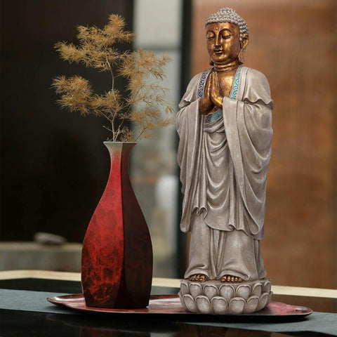 Asian Bodh Gaya Buddha Garden Statue, 30 Inch Tall Cast Stone Resin Sculpture With Faux Stone And Metallic Finish beside a vase