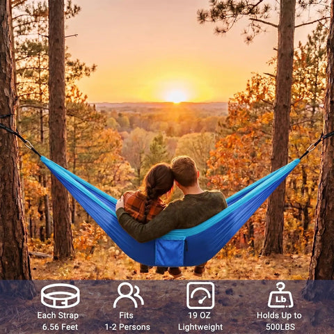 Couple relaxing in blue Ultra Lightweight Parachute Nylon Hammock With Tree Straps For Camping Backpacking Hiking Or Beach Adventures
