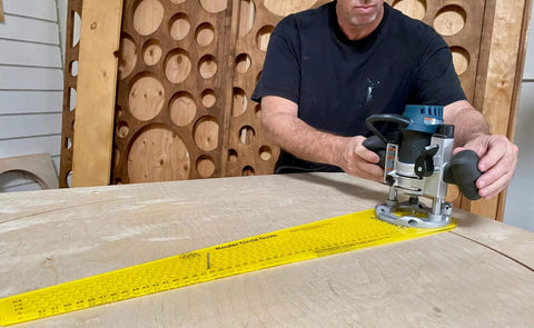 Person using Circle Cutter Jig For Routers Delivers Boss Level Precision Cut 184 Perfect Circles on a wooden board