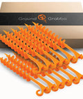 Orange Screw In Tent Stakes 12 Pack For Sand No Drill Needed Ground Anchors with maximum grip displayed in front of box