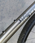 Terske water bottle cage bolts, black titanium, 4-pack installed on bike frame (side view).
