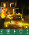 Outdoor pathway with Six Pack 51 LED Solar Torch Lights With Flickering Flame 23 Inch Tall lighting up garden at night