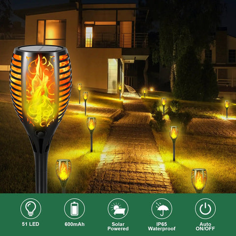 Outdoor pathway with Six Pack 51 LED Solar Torch Lights With Flickering Flame 23 Inch Tall lighting up garden at night