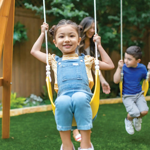 Kids enjoying Weatherproof Wooden Swing Set For Backyard With UV And Mold Protection, Durable Pre Treated Lumber.