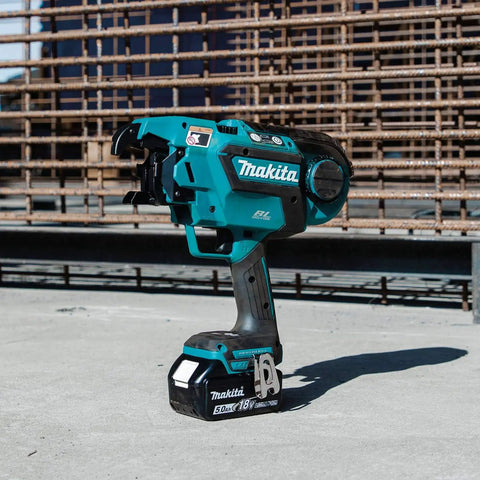 Makita XRT01TK 18V LXT Brushless Cordless Rebar Tying Tool Kit With 5.0Ah Battery on a construction site.