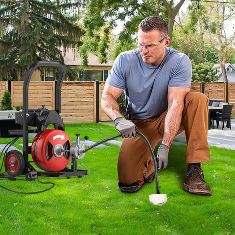 Powerhouse Electric Drain Auger With Auto Feed Design Tough As Nails 75 Foot Steel Cable Sewer Snake in use outdoors.
