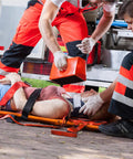 EMS team using Color Coded Backboard Spine Board Straps For Quick Immobilization On Stretcher 10 Point System Industrial Grade Nylon Spider Straps For EMS Pros And Medical Teams to secure patient.