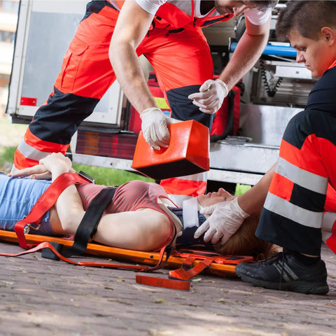EMS team using Color Coded Backboard Spine Board Straps For Quick Immobilization On Stretcher 10 Point System Industrial Grade Nylon Spider Straps For EMS Pros And Medical Teams to secure patient.