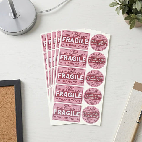 Hot Pink Fragile Stickers For Shipping Do Not Bend Do Not Crush Handle With Care Labels Pack Of 500 on a desk