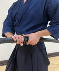 Person holding Polypropylene Practice Katana for Dojo Training Black Blade Not For Full Contact Sparring Lightweight Yet Durable Training Sword