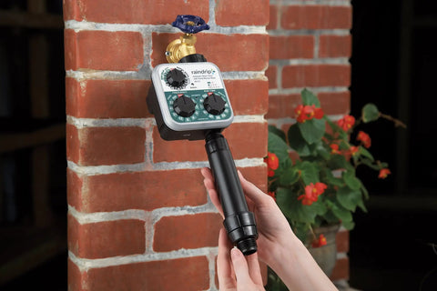 Automatic Drip Irrigation Kit With Timer For Ground Cover And Flower Beds installed on a brick wall