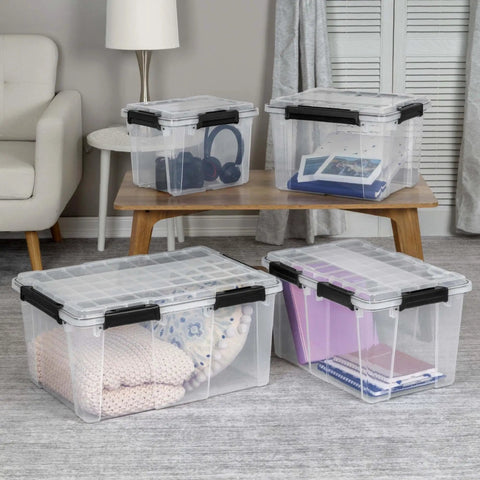 Massive 80 Quart Clear Plastic Storage Bin With Hella Tight Waterproof Seal And Heavy Duty Latches For Stacking Bulky Comforters And Camping Gear In Every Corner with blankets and notebooks displayed.