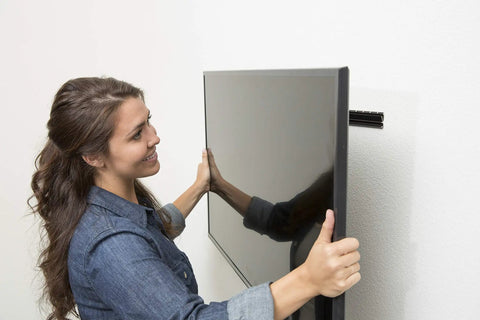 Person installing a 55 inch TV using No Stud TV Wall Mount For 26 To 55 Inch Flat Screens With Built In Level Quick 10 Minute Install