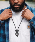 Close-up of person wearing Fire Starter Necklace With Hex Ferro Rod Striker And Paracord Lanyard Up To Twelve Thousand Strikes Waterproof