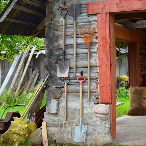 Garden tools including shovels and a rake hanging on a barn wall using 30 Pack Heavy Duty Wall Mount Garage Hooks For Bikes, Ladders, Tools, And Garden Equipment, Anti Slip Steel Utility Hangers To Free Up Space In Your Garage, Shed Or Workshop.