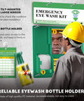 Portable Eye Wash Station Wall Mounted OSHA Approved Emergency Eye Wash Kit With Upgraded Bottle Holder And Larger Mirror Plus Sixteen Point Nine Ounce Bottles No Solution Included Green Cap Ready For Any Spill in use with worker accessing bottle.