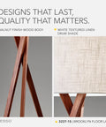 Close-up of walnut tripod base and white linen shade of Table Lamp With Walnut Tripod Base And White Linen Drum Shade For Bedside.