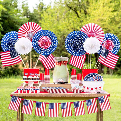 Patriotic party table setup with flags, featuring Patriotic Paper Straws 100 Pack With Red Blue White Flag Designs 7.75 Inch Biodegradable
