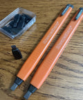 AlwaysSharp Refillable Mechanical Carpenter Pencil Two Pack With Eight Replacement Black Graphite Tips And Pocket Clip, shown on a table