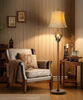 Cozy Farmhouse Vibe Antlers Floor Lamp With Night Light, Faux Leather Bell Shade, Brown Finish in a rustic living room