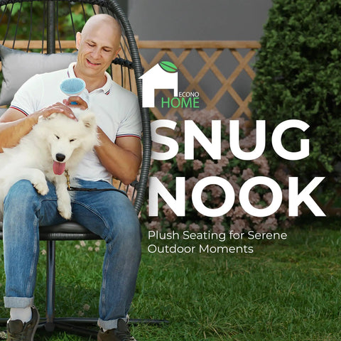 Man and dog sitting on Hanging Egg Chair with Stand for indoor outdoor chill, plush washable cushions, in garden setting.