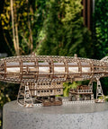 Luminous Zeppelin LED 3D Wooden Puzzle Kit For Adults displayed outdoors on a stand, showcasing vintage airship design.