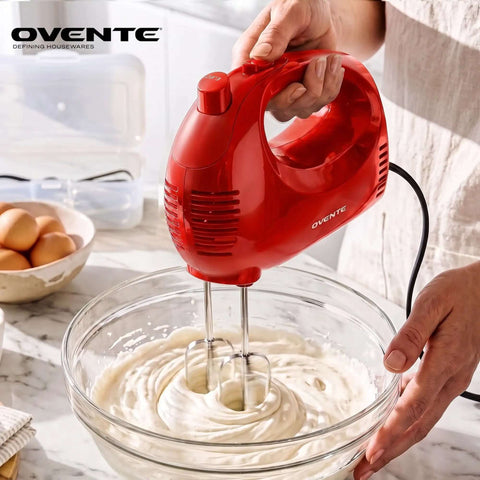 Top Tier Five Speed Electric Hand Mixer With Slick Adjustable Controls And A Sturdy Red Storage Case For Blazing Through Whipping Cream, mixing batter in glass bowl