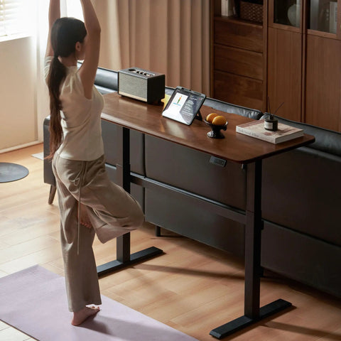 Top Shelf Electric Standing Desk With Ultra Wide Worktop Effortless Height Adjustment Hidden Wire Basket Natural Walnut Finish in home office.