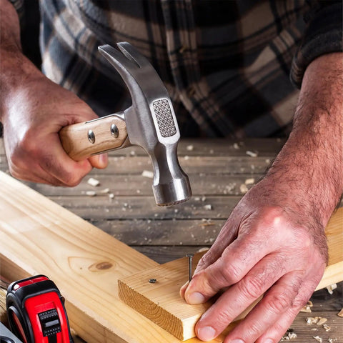 Man using 2 Pack 17 Inch Straight Wood Hammer Handles Replacement with Mounting Hardware for Titanium Hammers on wood surface