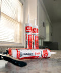 Silicone Acrylic Caulk And Sealant For Kitchen Bathroom And Windows 100 Percent Waterproof Paintable With Duraguard White 5.5 Oz Easy Toolin And Durable Seal Made In USA tubes on a kitchen counter